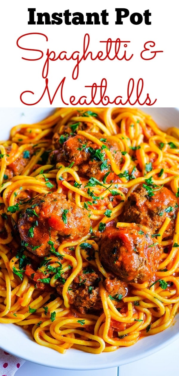 A close up of this Instant Pot spaghetti and meatballs with noodles, marinara sauce, and chopped basil