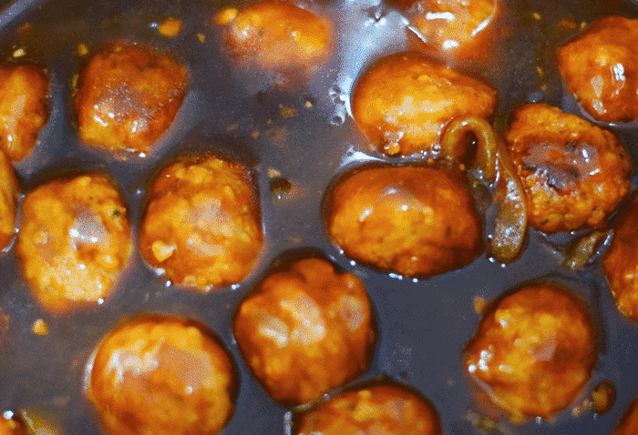 A close up of the meatballs in the gravy for this instant pot meatballs and gravy recipe