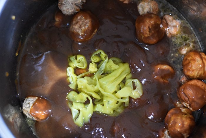 A close up of the meatballs in the gravy for this instant pot meatballs and gravy recipe