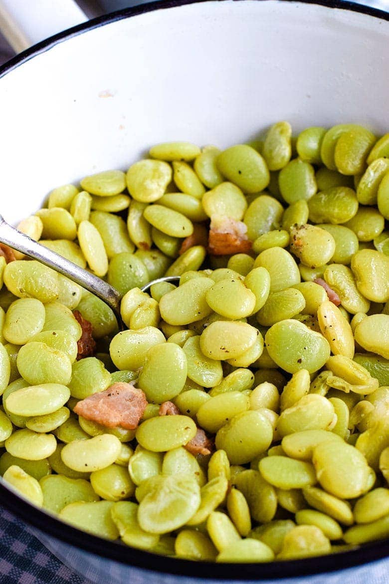 A white serving bowl filled with these southern-style baby lima beans