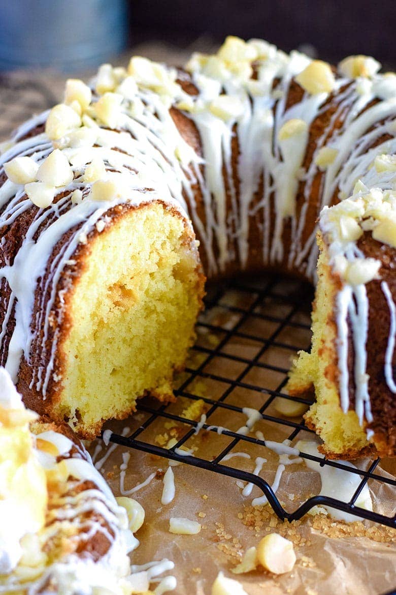 white chocolate macadamia nut pound cake with icing, whipped cream, and shredded coconut
