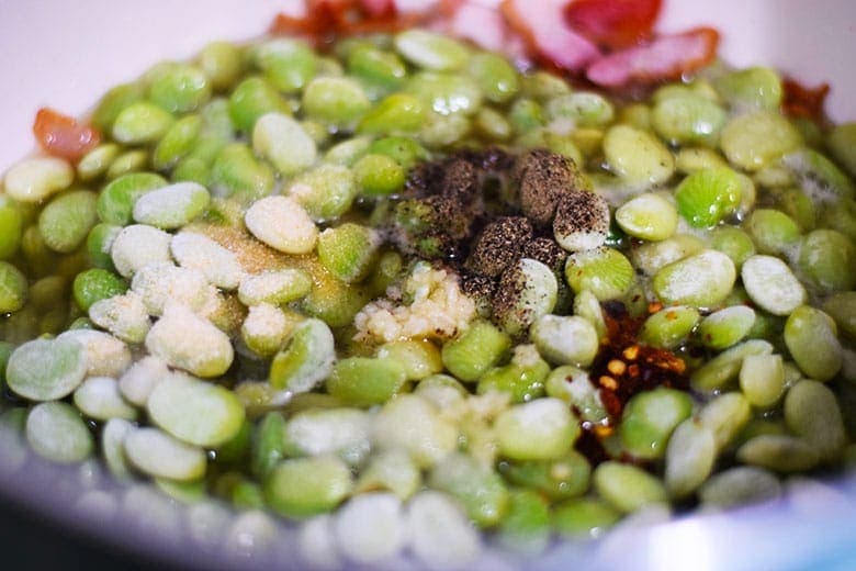 a closeup of these southern-style baby lime beans with the seasonings