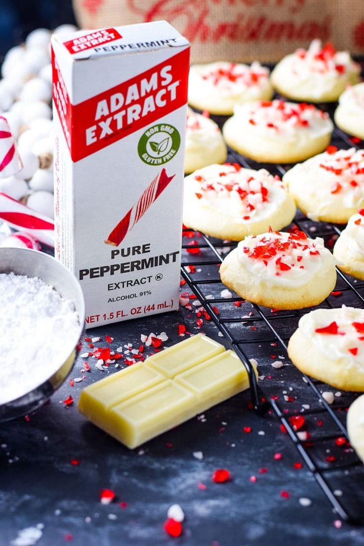 Festive peppermint melt-away cookies with white chocolate icing and candy cane sprinkles with peppermint extract and white chocolate 
