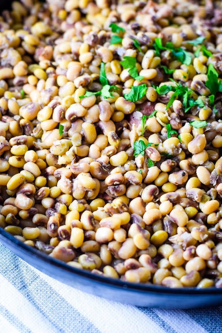 A large bowl filled with these homemade black eyed peas recipe garnished with fresh parsley