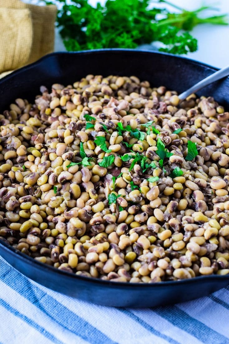 A large bowl filled with these homemade black eyed peas recipe garnished with fresh parsley