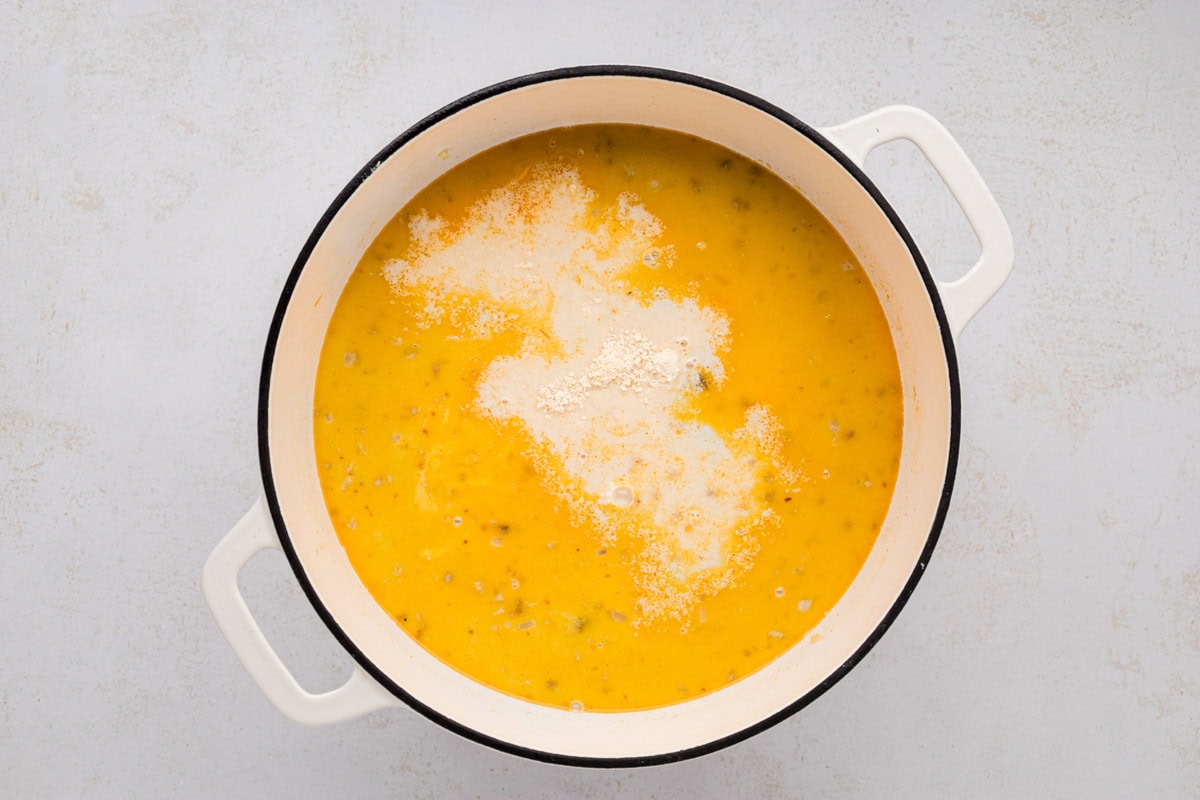 Cream and parmesan cheese added to the soup pot.