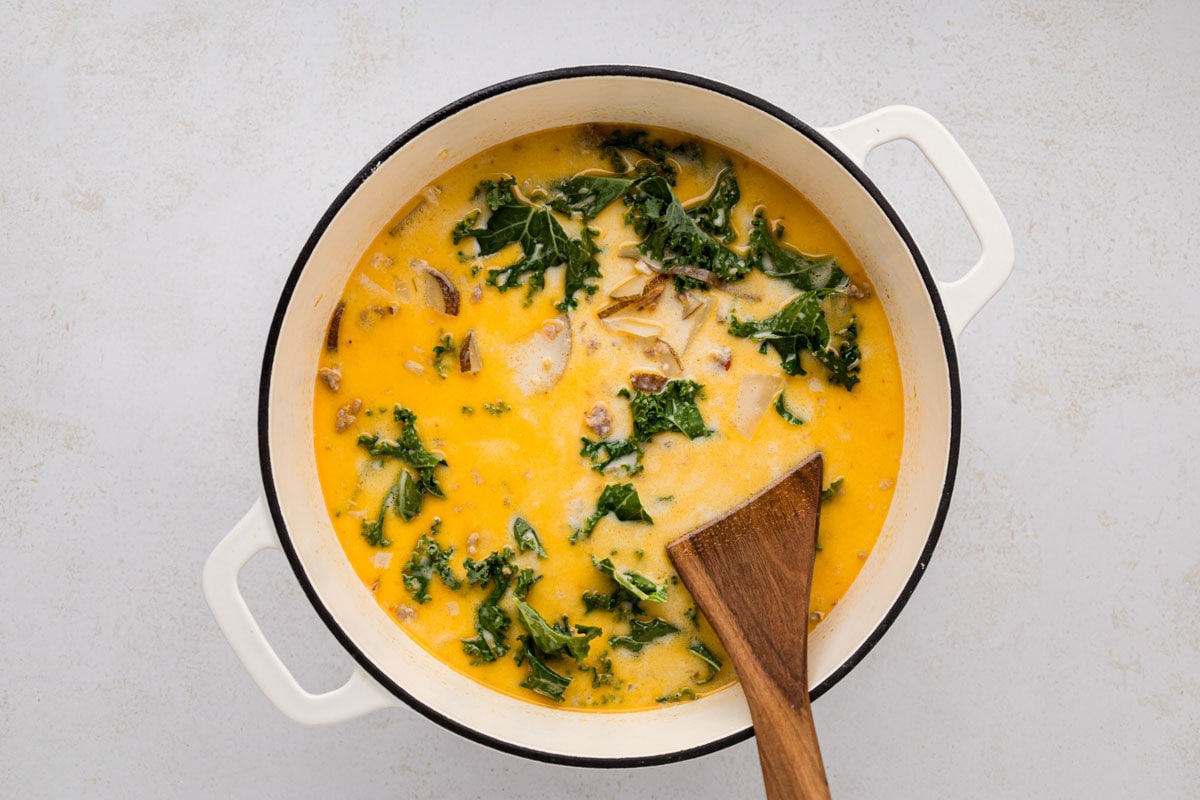 All the ingredients stirred into together to make zuppa toscana soup.