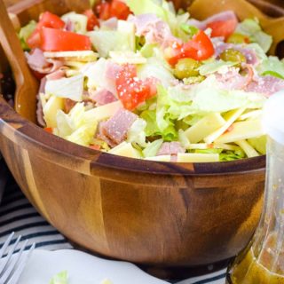 A large wooden serving bowl of this Columbia Restaurant's 1905 salad recipe