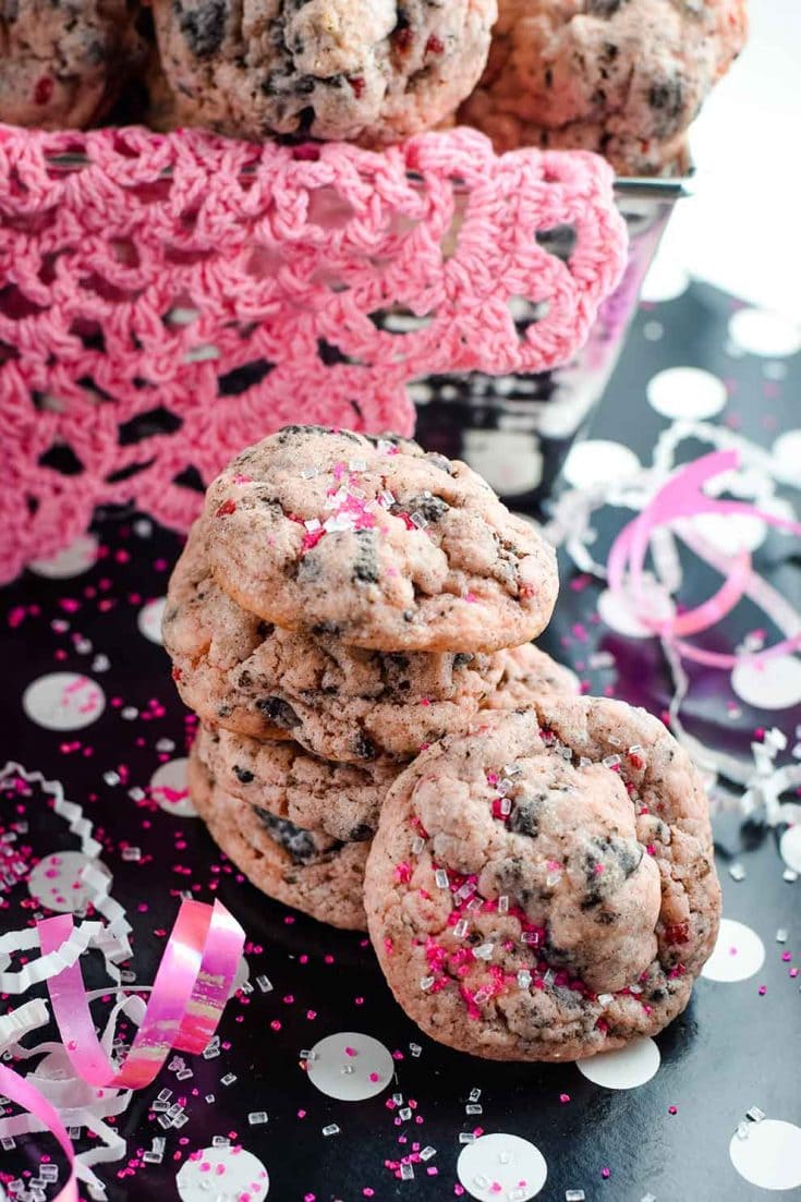 A festive stack of strawberry Oreo cheesecake cookies with pink confetti