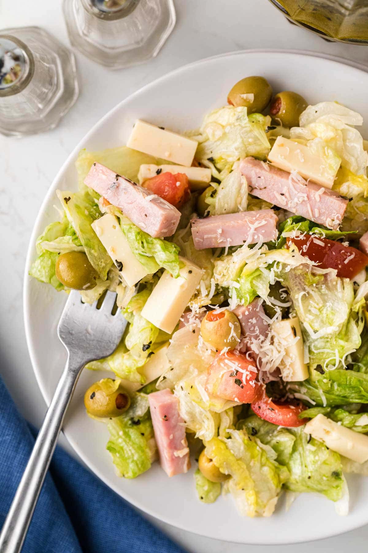 A white plate with salad.
