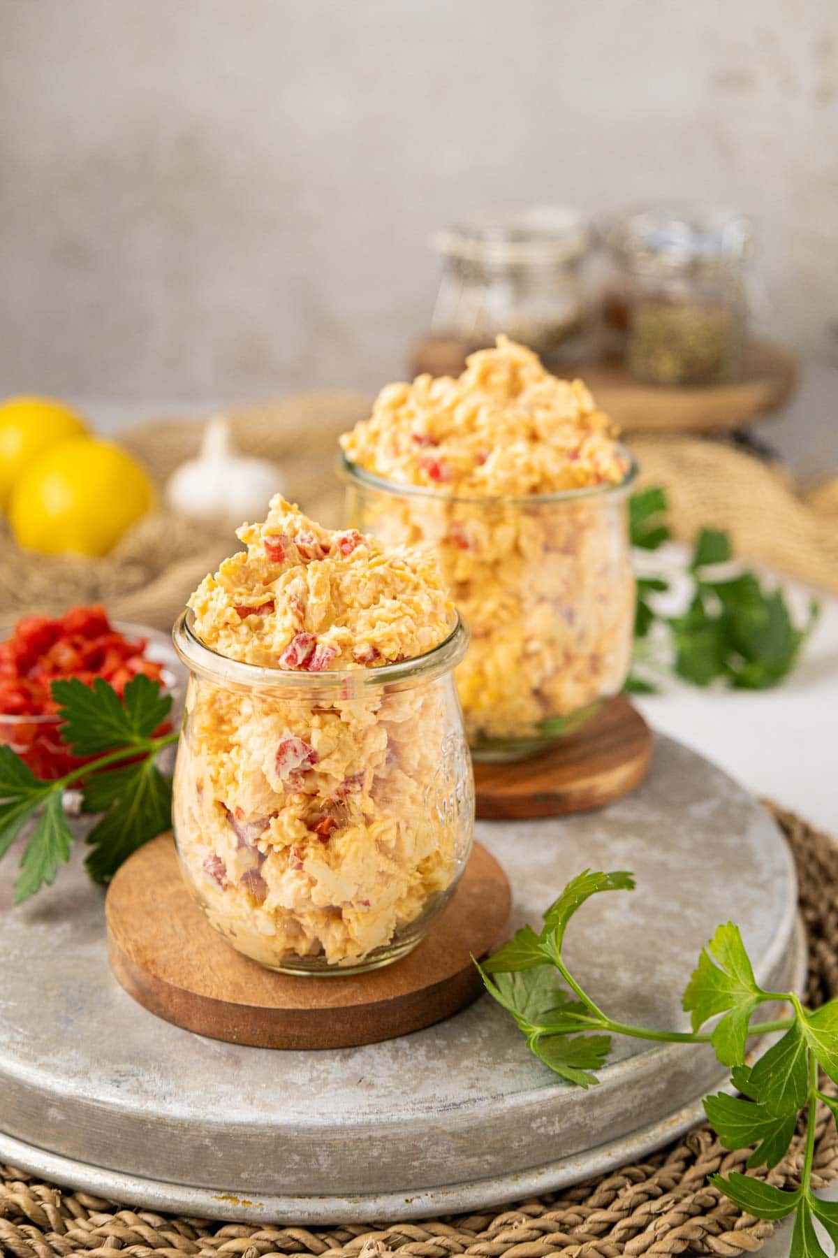 Homemade pimento cheese in two Weck jars on a serving tray.