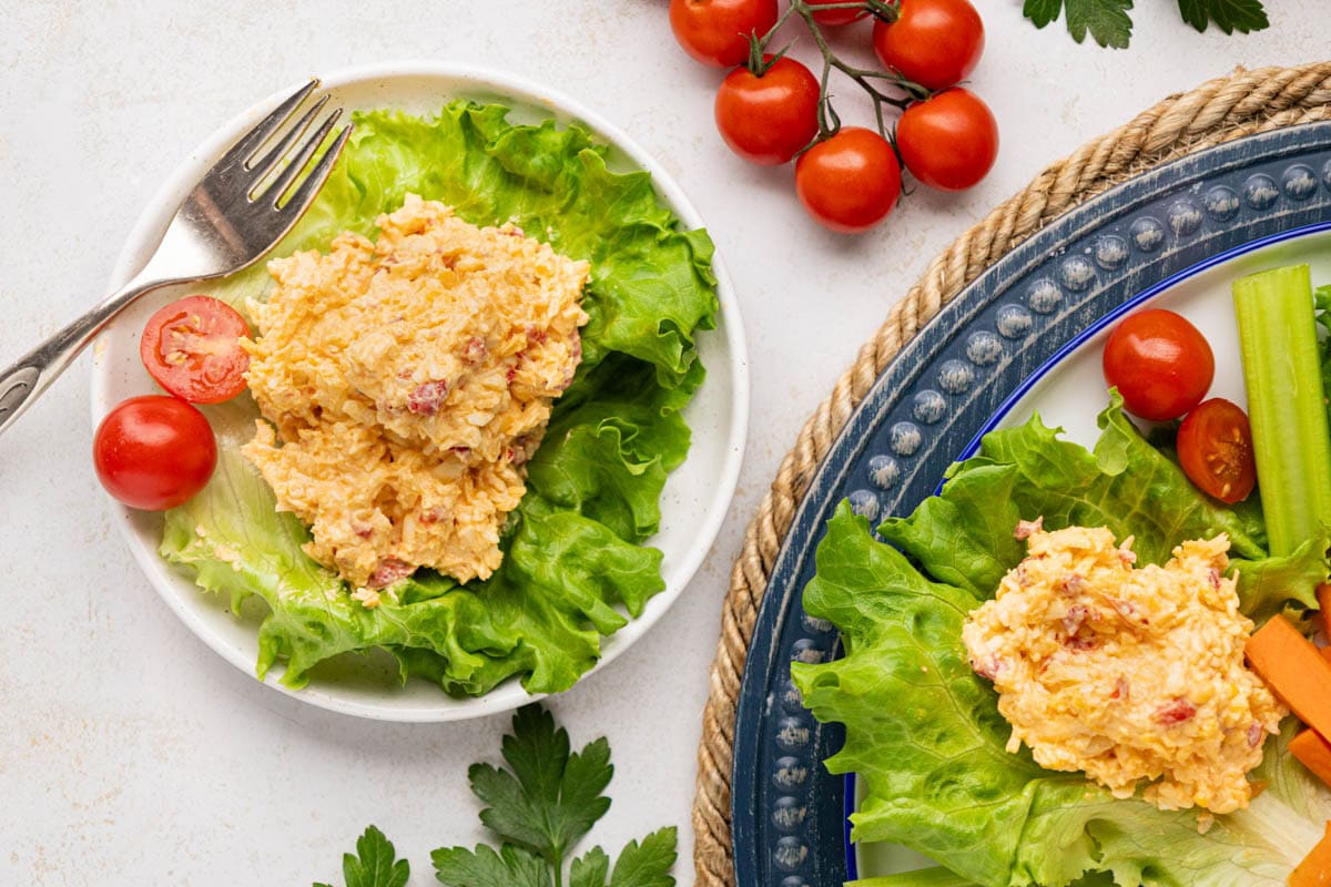A scoop of southern pimento cheese on a bed of lettuce.