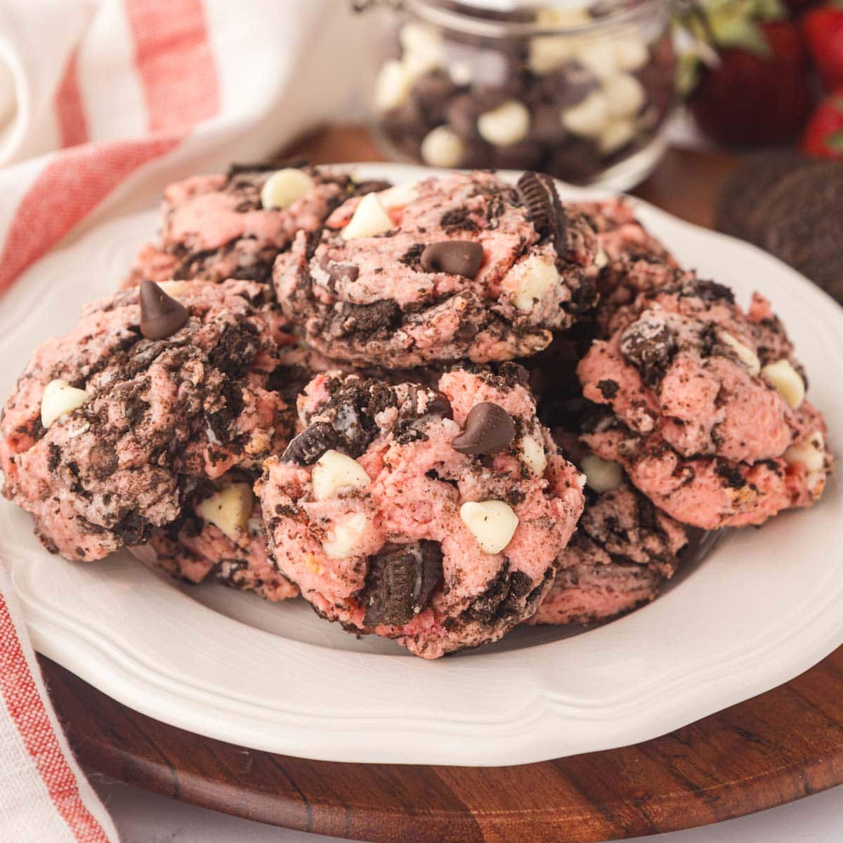 Strawberry Oreo cheesecake cookies on a white serving plate.