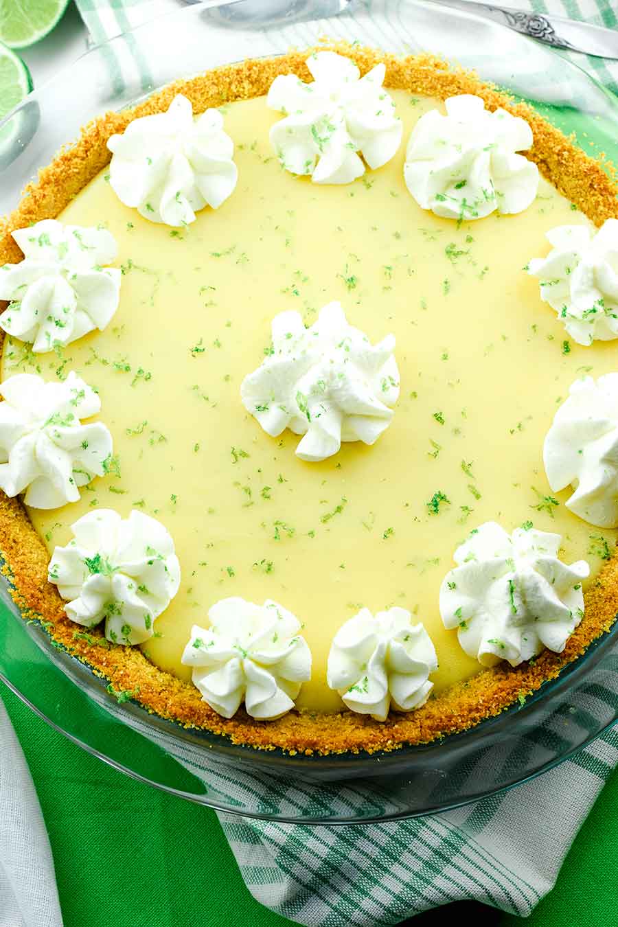 The Best Key Lime Pie topped with whipped cream and lime zest