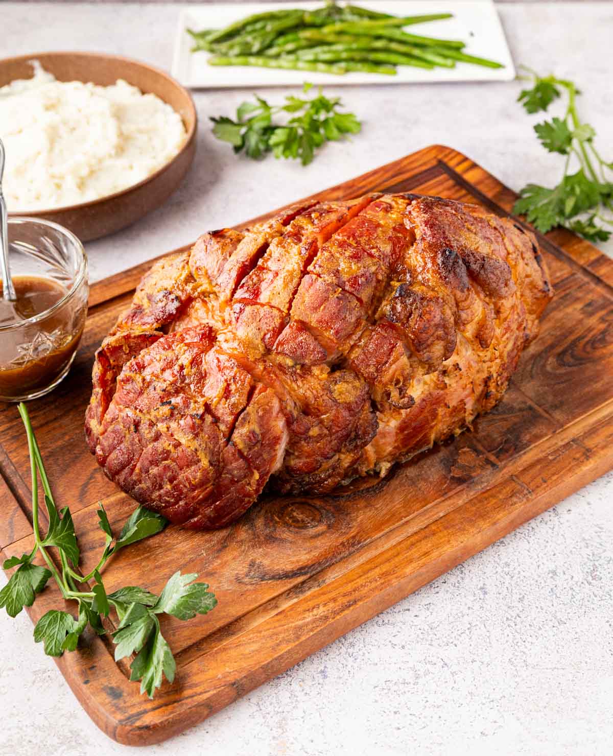 Cola and Mustard Glazed Ham A Coca-Cola brown sugar and mustard glazed ham on a cutting board.