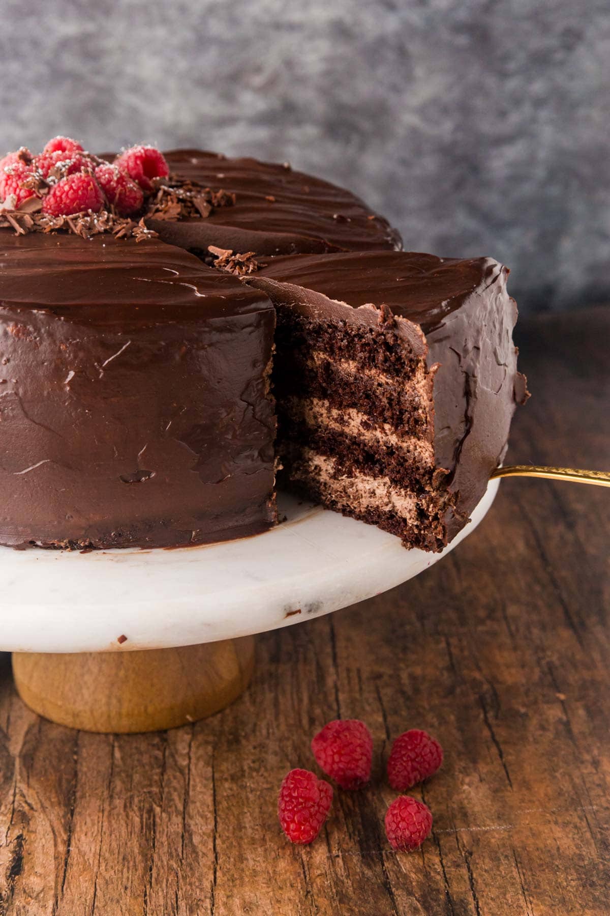 Removing a slice of cake with a cake server.