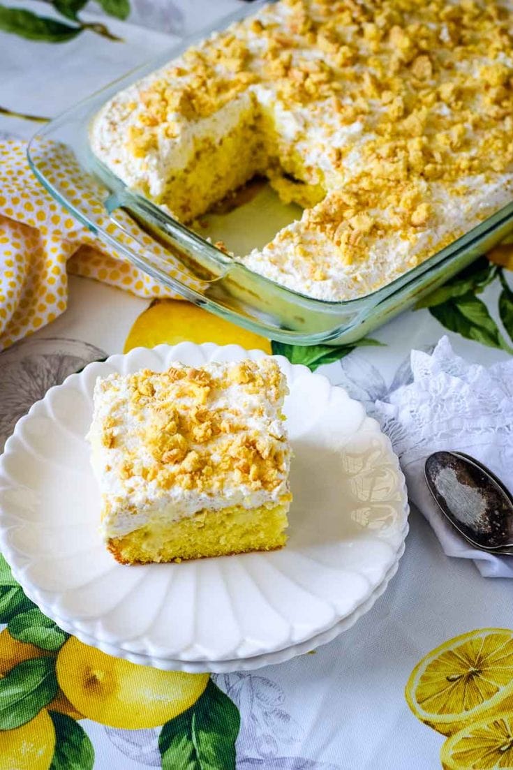 a single slice of lemon poke cake on a white plate