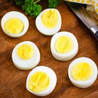 Perfect Instant Pot Boiled Eggs sliced in half to reveal yellow yolks and egg whites