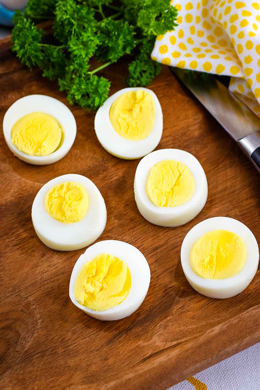 Perfect Instant Pot Boiled Eggs sliced in half to reveal yellow yolks and egg whites