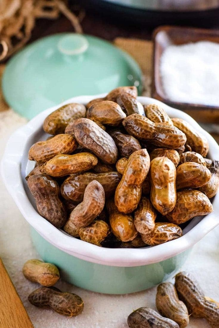 Boiled peanuts in sage green and white bowl.