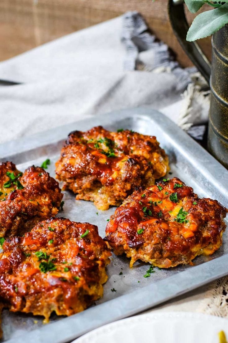 Mini BBQ bacon cheddar meatloaves on a silver tray.