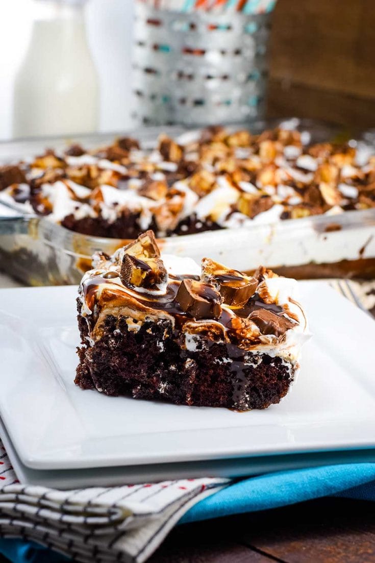 Snickers Poke Cake on White Plate