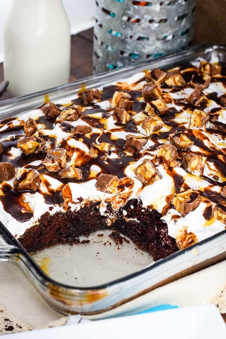 Decadent Snickers Poke Cake in a 9 X 13 baking dish
