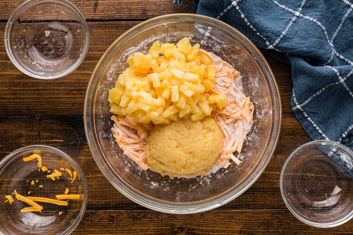 Drained crushed pineapple and pineapple tidbits added to flour cheese mixture.
