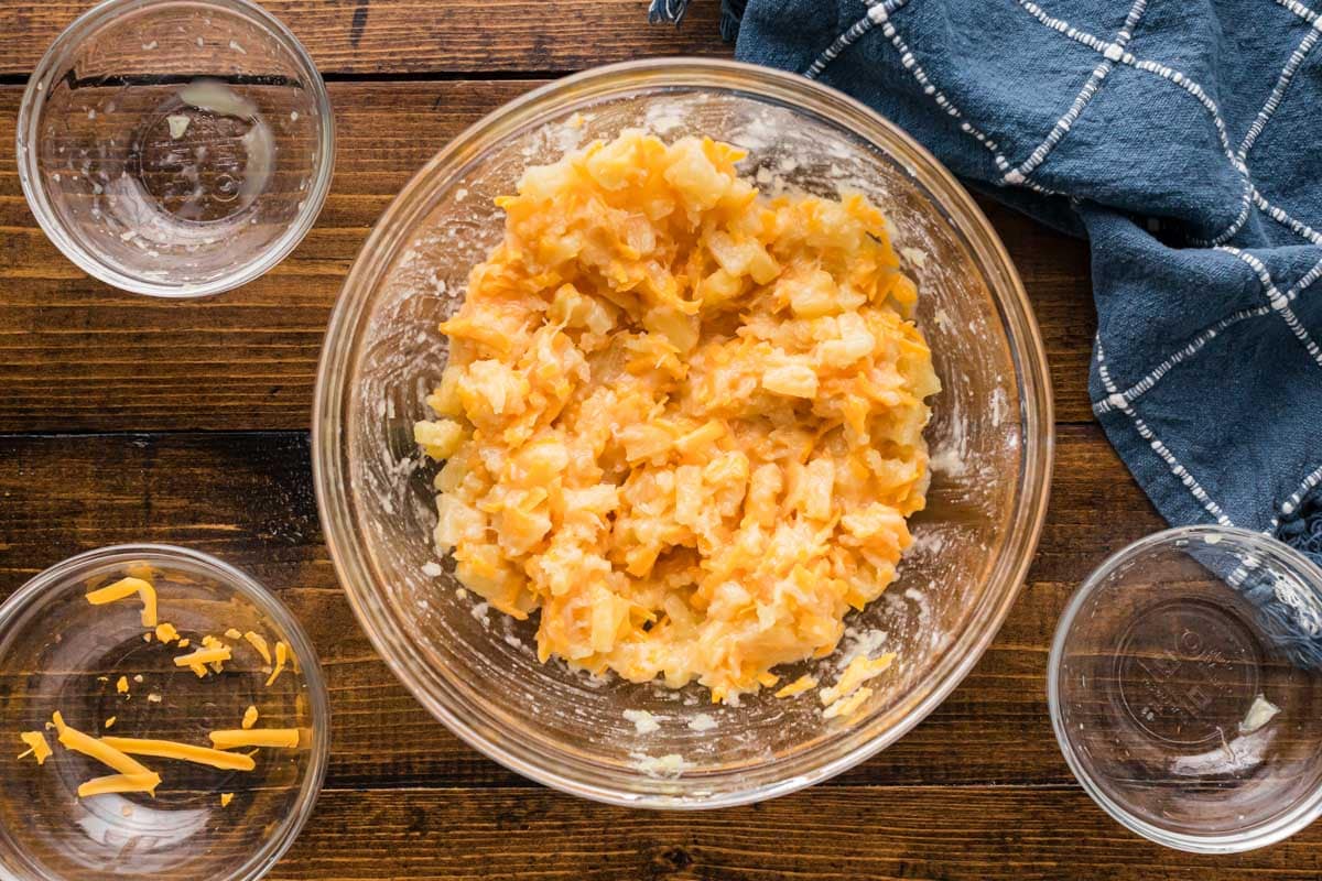 Pineapple cheese base mixture stirred to combine in a clear bowl.