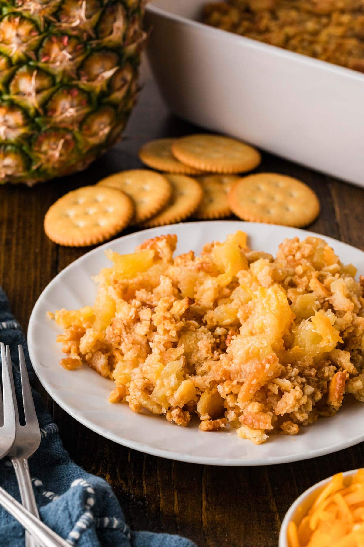 A plate of a serving pineapple cheese casserole.