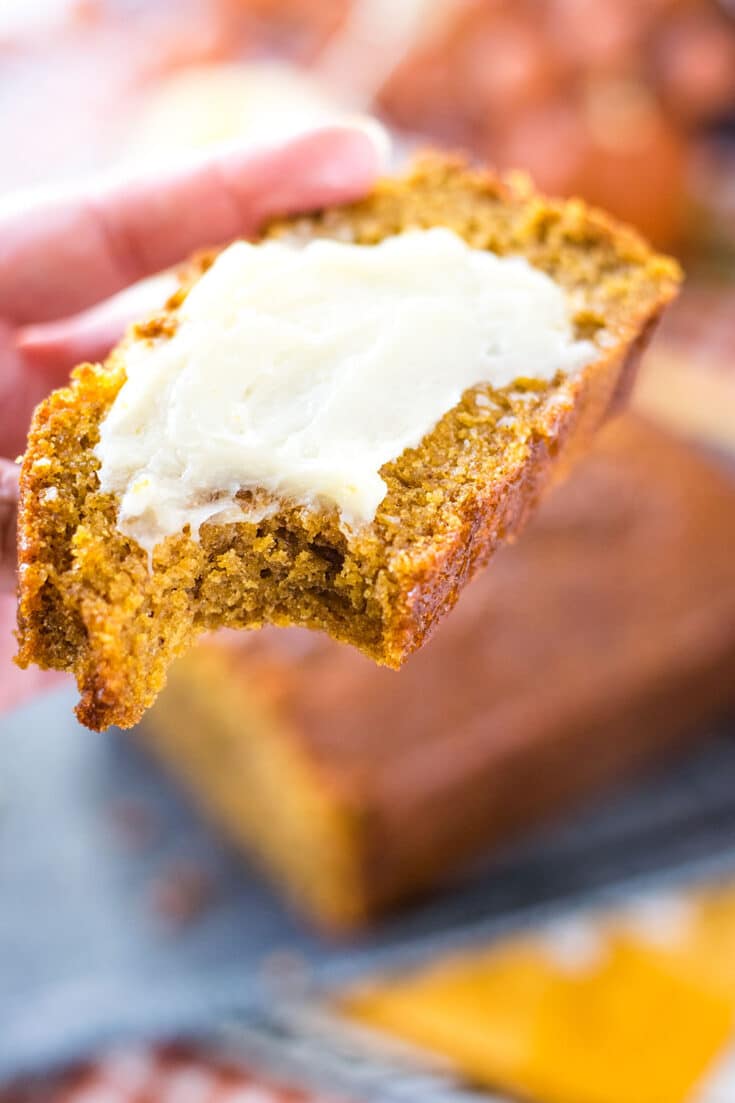 A close-up of a piece of banana bread with butter spread over the slice.