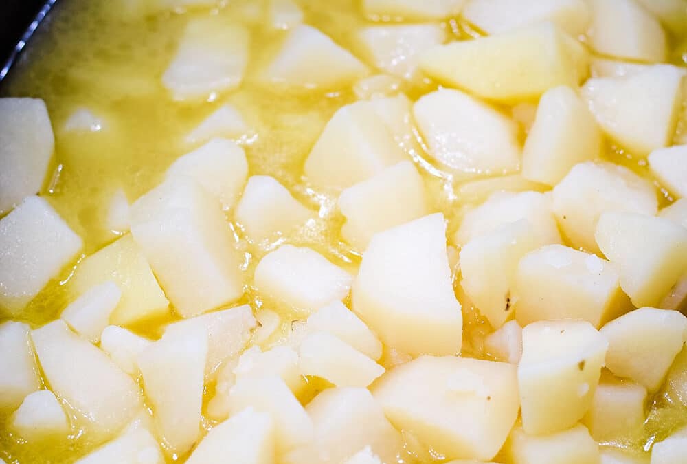 Cubed potatoes with butter in a crock pot.
