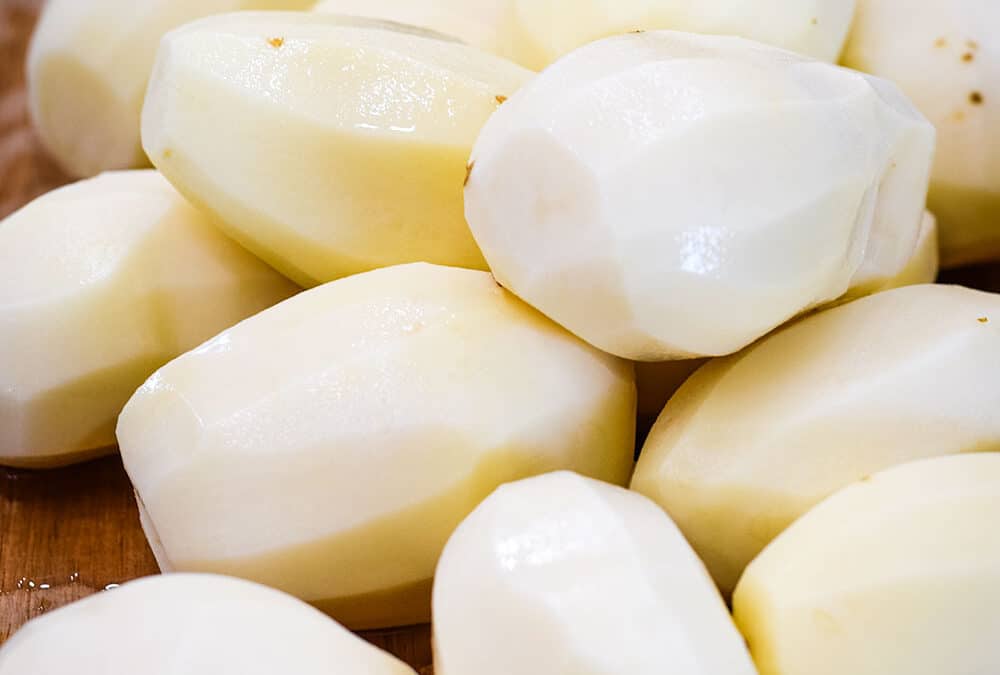 An up-close of peeled potatoes.