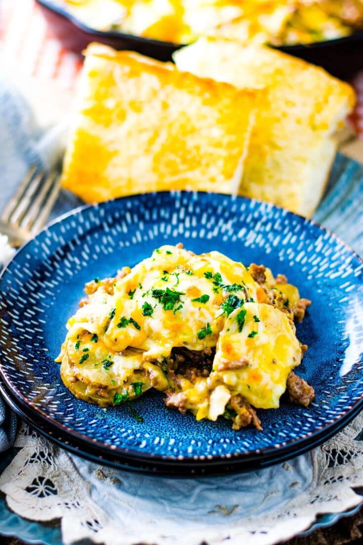 A single serving of this Easy Ground Beef and Potatoes Skillet on a dark blue plate