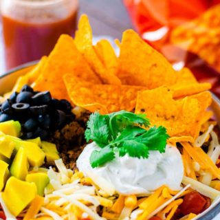 tossed green salad with seasoned ground beef, beens, cheese, lettuce, crumbled nacho chips combined to create a Dorito Taco Salad Recipe