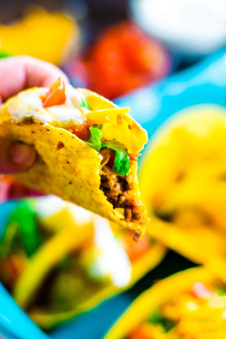 Oven baked beef taco with lettuce tomato and sour cream