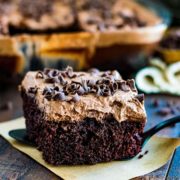 A piece of chocolate cake on a rustic set table.