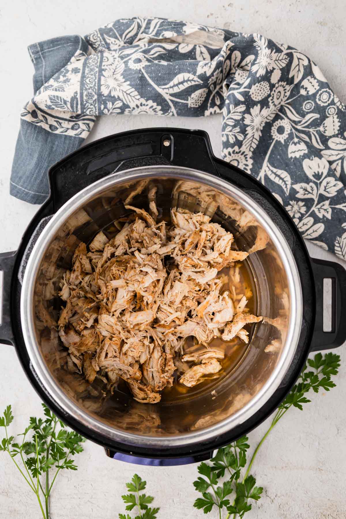 Shredded chicken added back into the instant pot with juices from cooking.