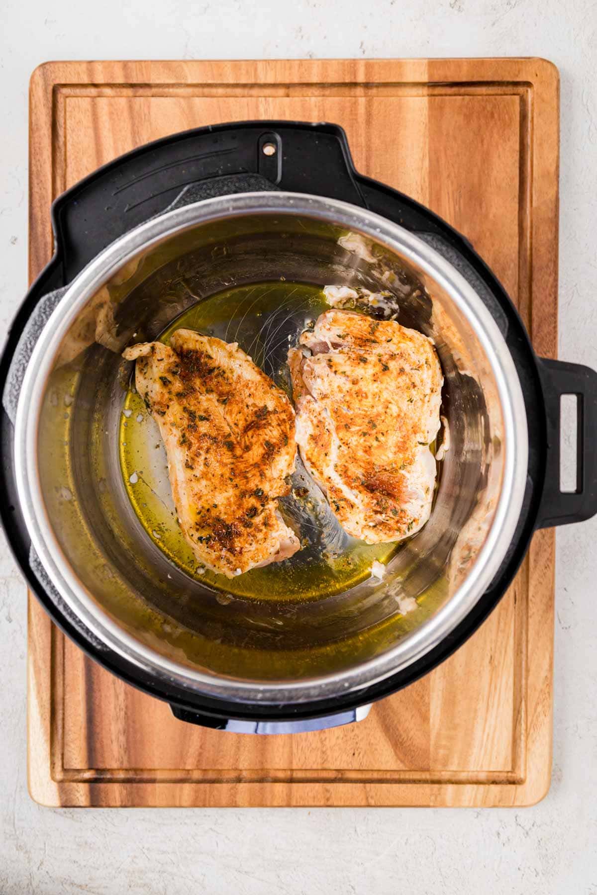 Seasoned chicken in the instant pot after being sautéd.