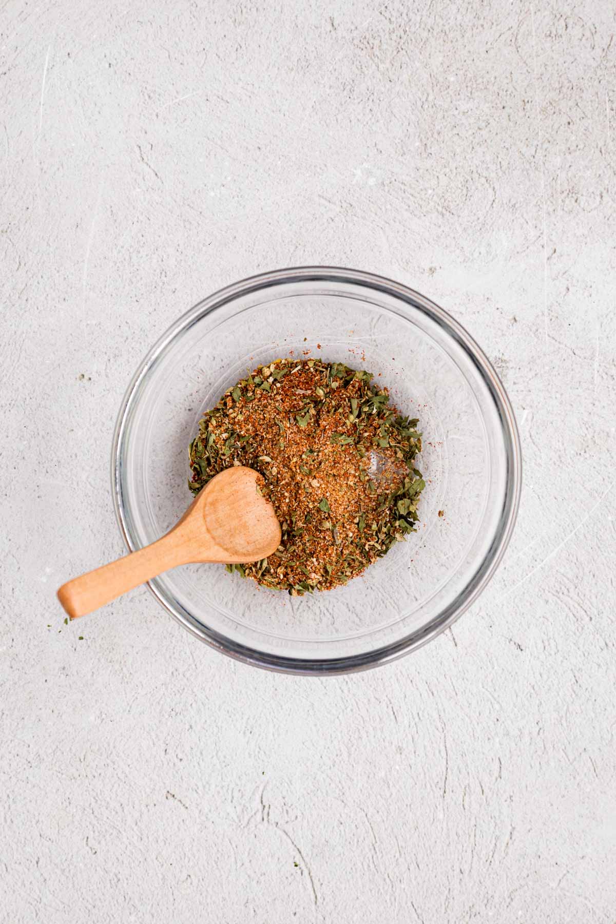 Seasoning for chicken mixed in a clear bowl.