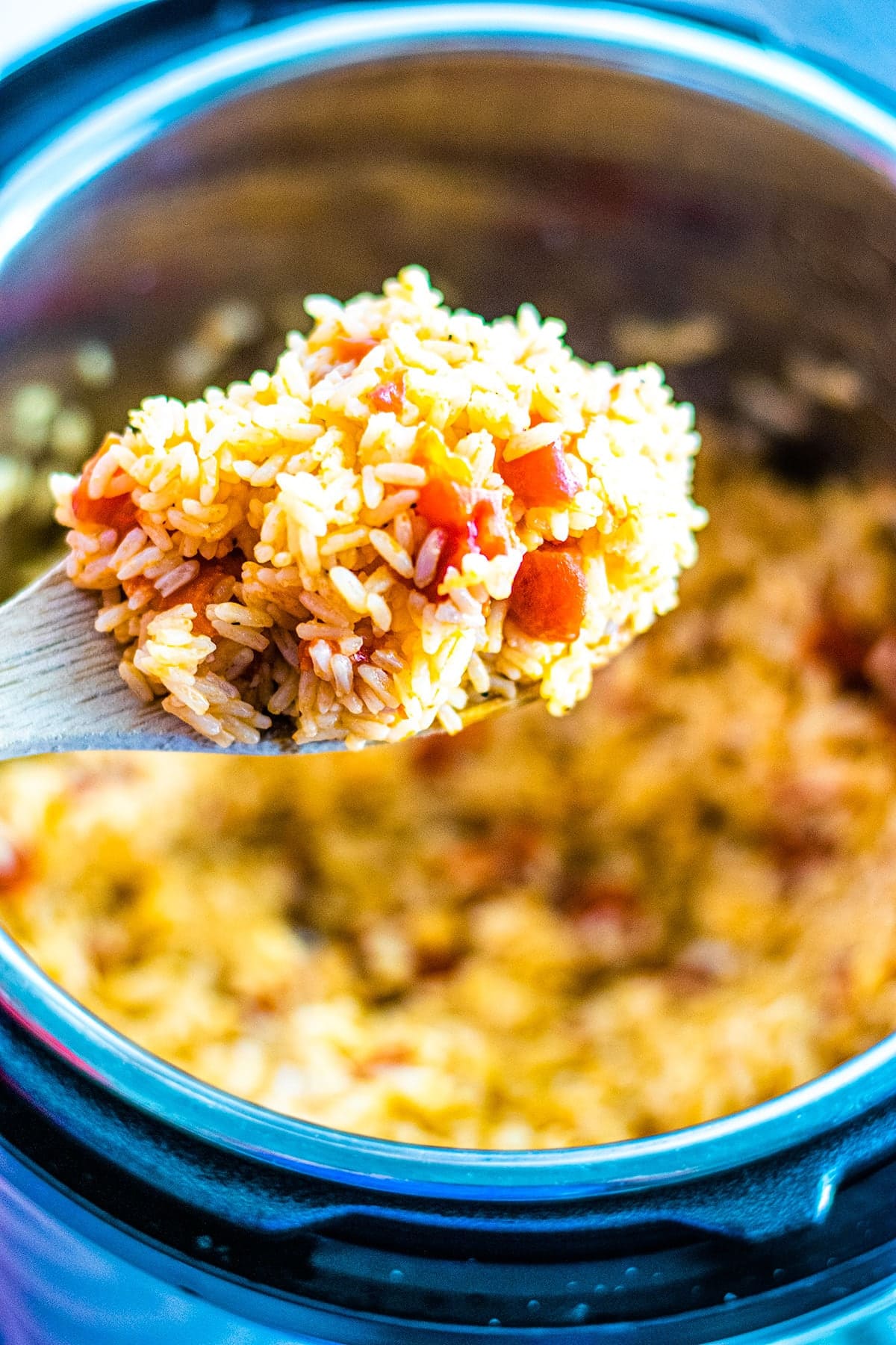 Wooden Spoon full of Instant Pot Tomatoes and Rice