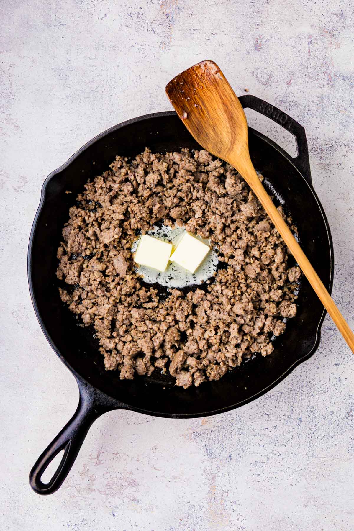 Two tablespoons of butter added to the skillet with cooked sausage.