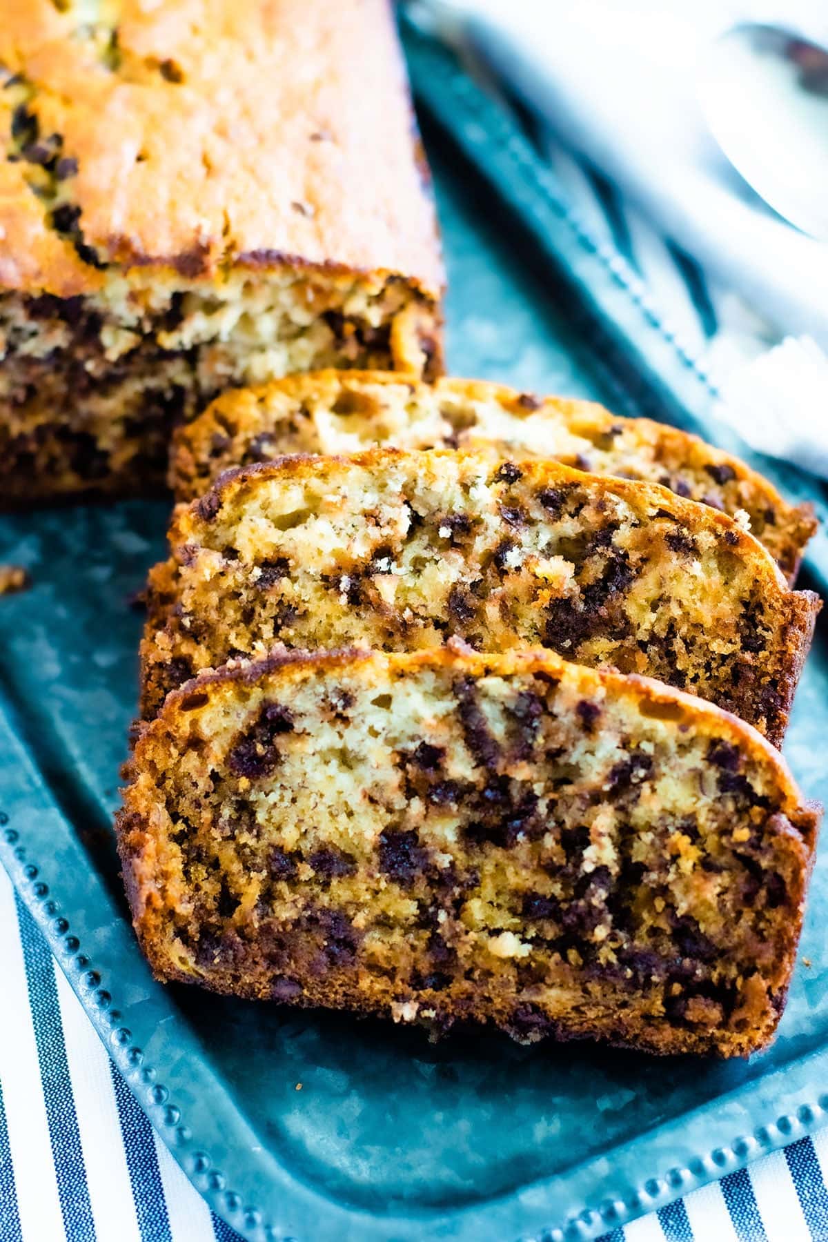 A close-up of a piece of banana bread on a silver tray.