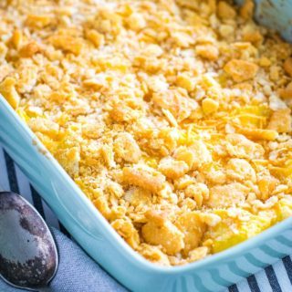 an overhead view of this cheesy yellow squash casserole in a light blue baking dish