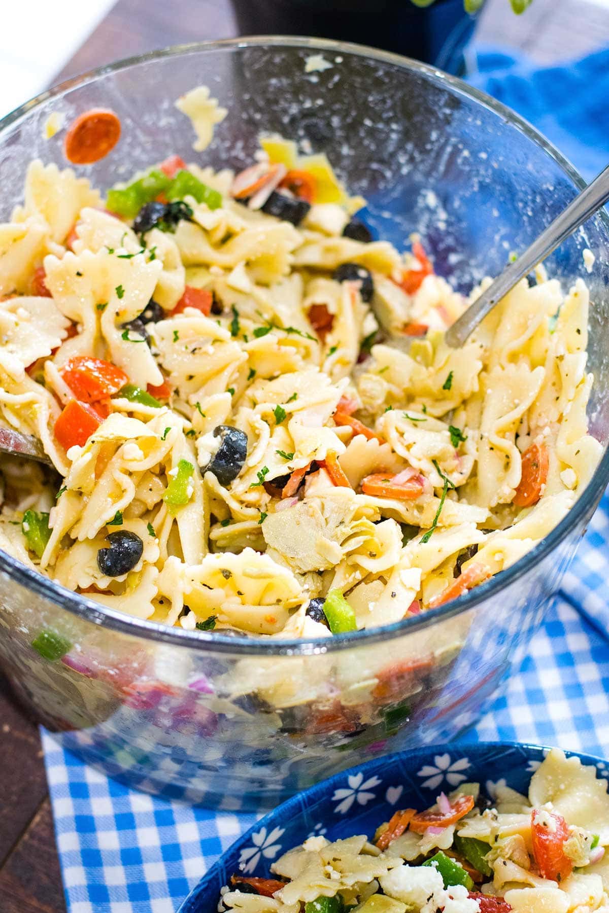 Bowl of tossed pasta salad with artichoke hearts and feta cheese