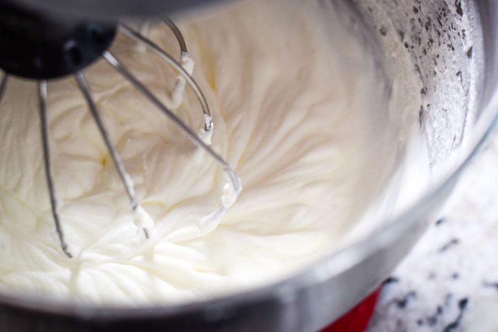 A close-up of a stand mixer bowl with Whipped Cream.