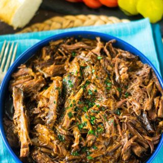 A bowl of roast beef debris on a blue plate.