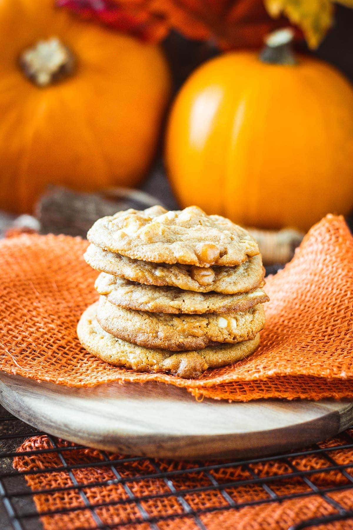 a stack of white chocolate caramel pumpkin spice cookies on a festive Halloween table scape