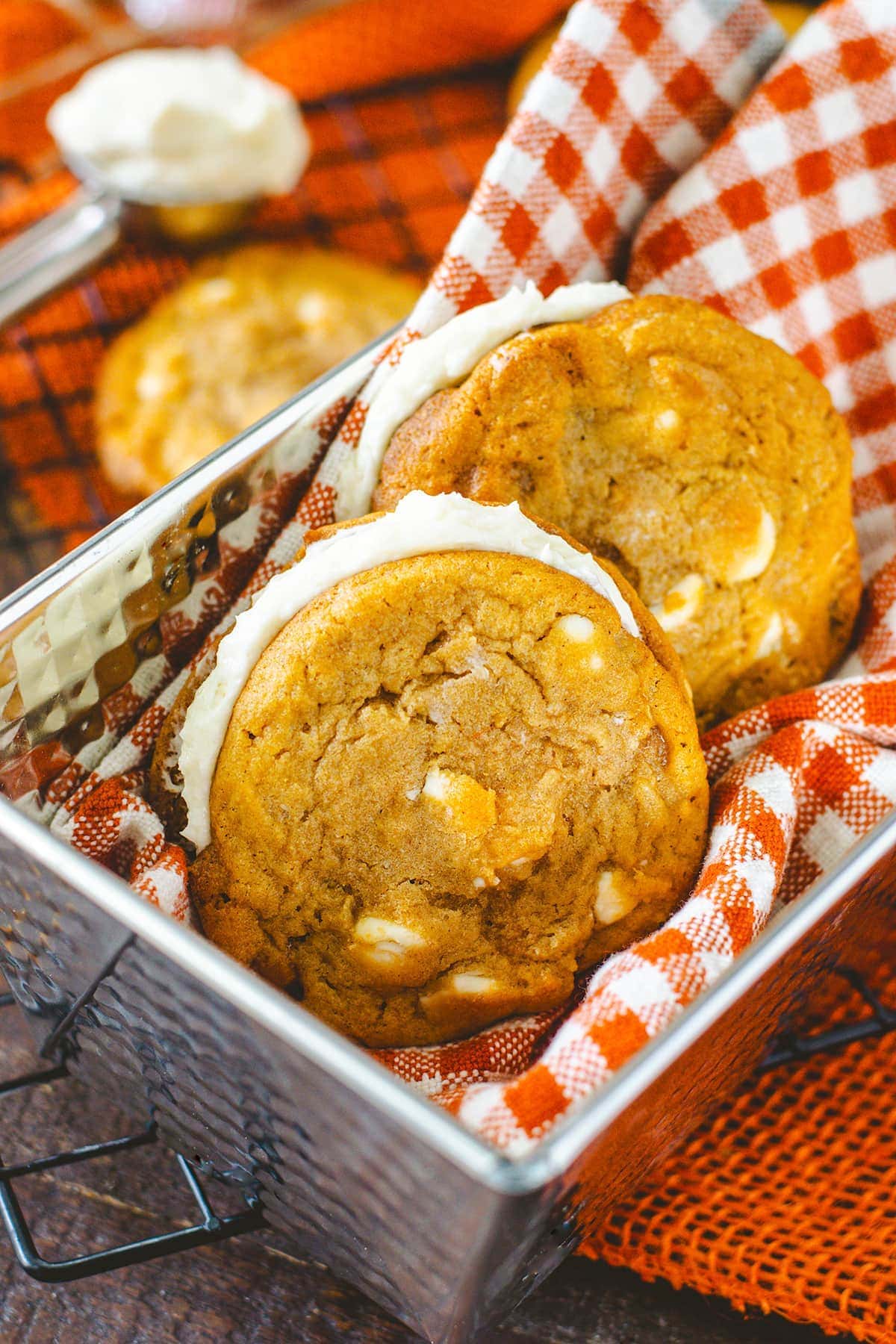 a closeup of these white chocolate caramel pumpkin spice sandwich cookie sandwiches