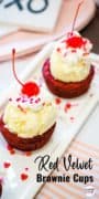 Red Velvet Brownie Cups topped with ice cream, whipped cream, a cherry, and sprinkles on a white tray.